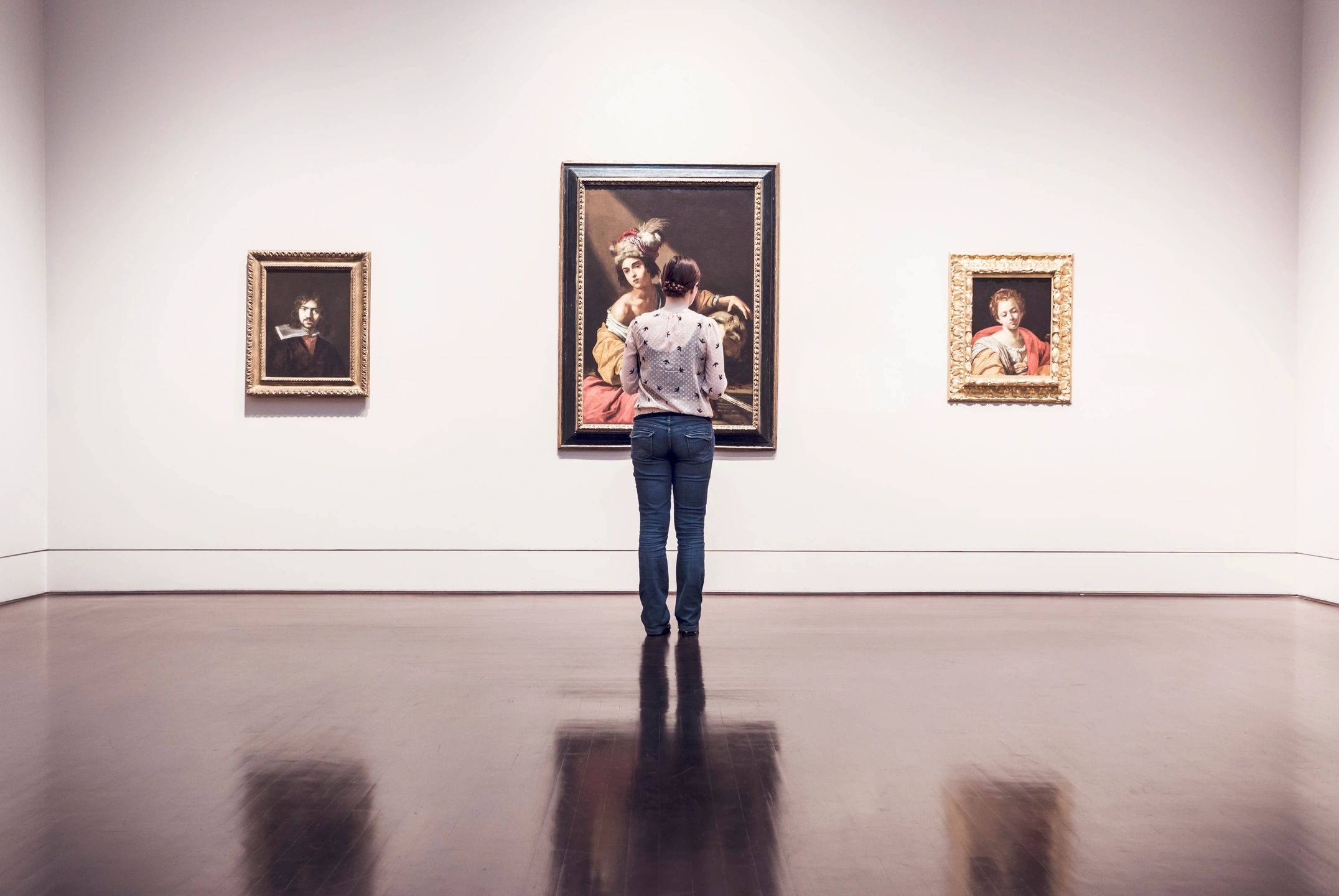Woman looking at art in a museum.